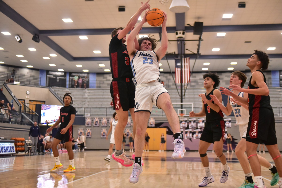 Edmond North senior Dylan Warlick fights for the ball during a recent game. Warlick attempts to lead the Huskies to a third straight Class 6A state title this week.